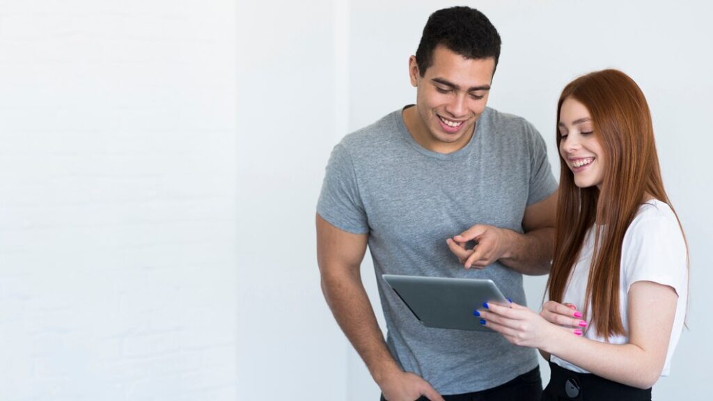 positive-young-man-woman-working-together_23-2148431387